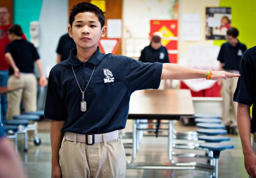 August Say, 12, holds out his arm to determine where he should stand in class in the new Dragon Leadership Corps at his middle school in Bowling Green, Ohio. 