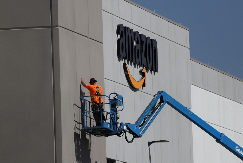 A Nationwide Campaign To Take Back Cities From The Corporations That - a worker makes repairs to a wall at a new amazon fulfillment center on august 10 2017 in sacramento california photo by justin sullivan getty images