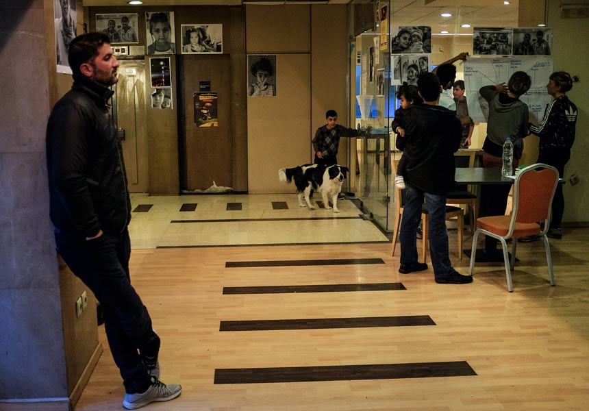 Residents and volunteers gather in the lobby of the former City Plaza hotel. (Photo by Nick Paleologos)